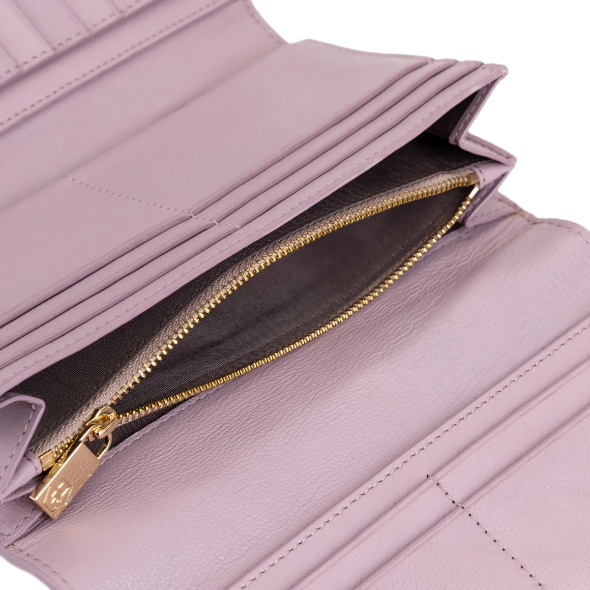 Close-up of pink leather trifold wallet showing card slots and gold zipper pull engraved with HC logo
