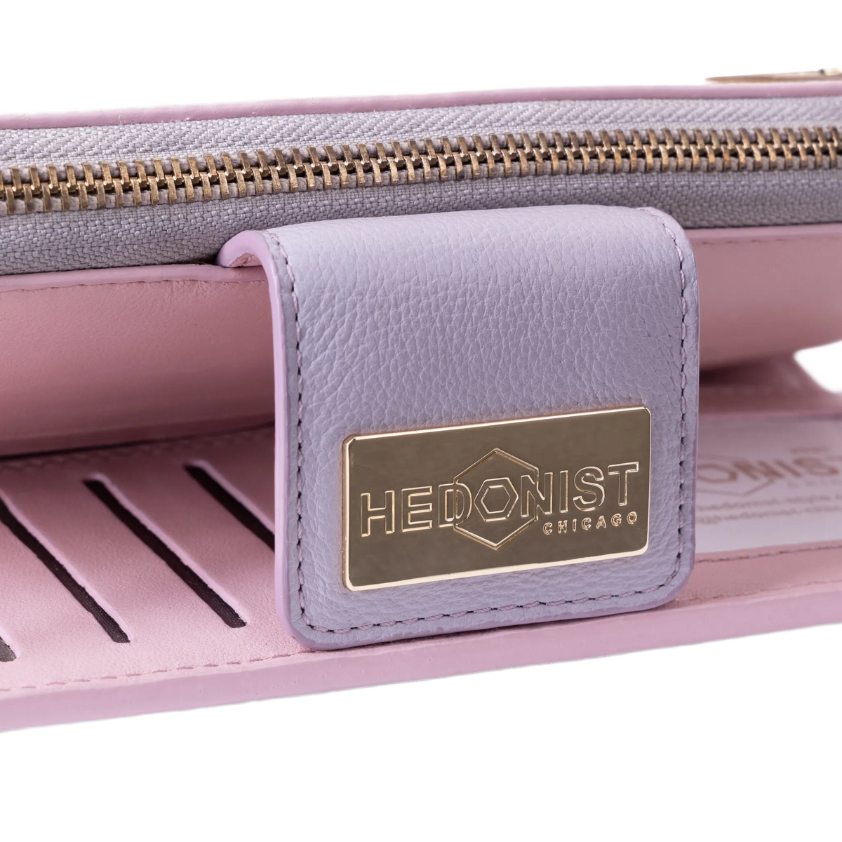 Snap-secured front flap detail on the pink pebbled leather travel wallet