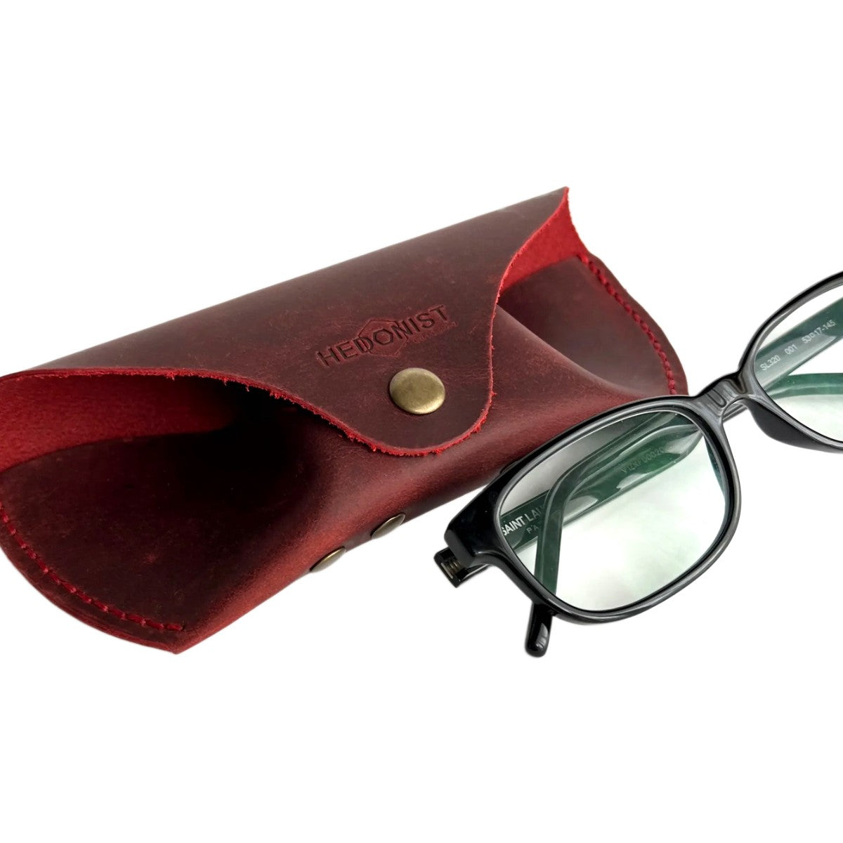 Soft Leather Eye Glasses Case in Red with black-framed eyeglasses resting beside it