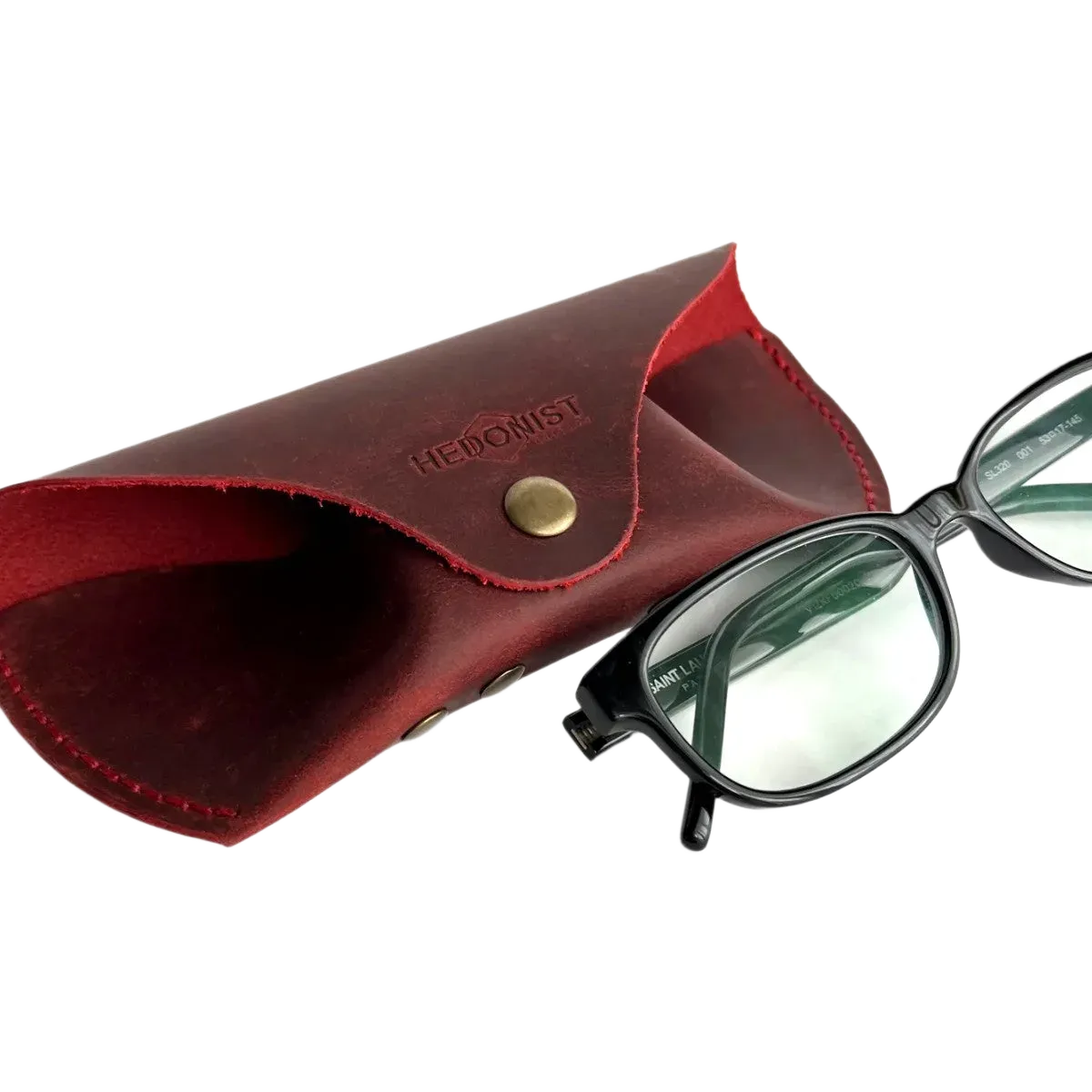 Soft Leather Eye Glasses Case in Red with black-framed eyeglasses resting beside it