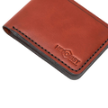 Handmade red brick leather bifold wallet, close-up of monogram branding