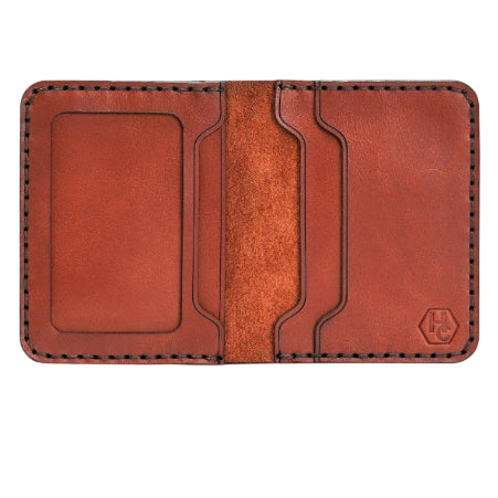 Handmade red brick leather bifold wallet with ID slot, open showing cards
