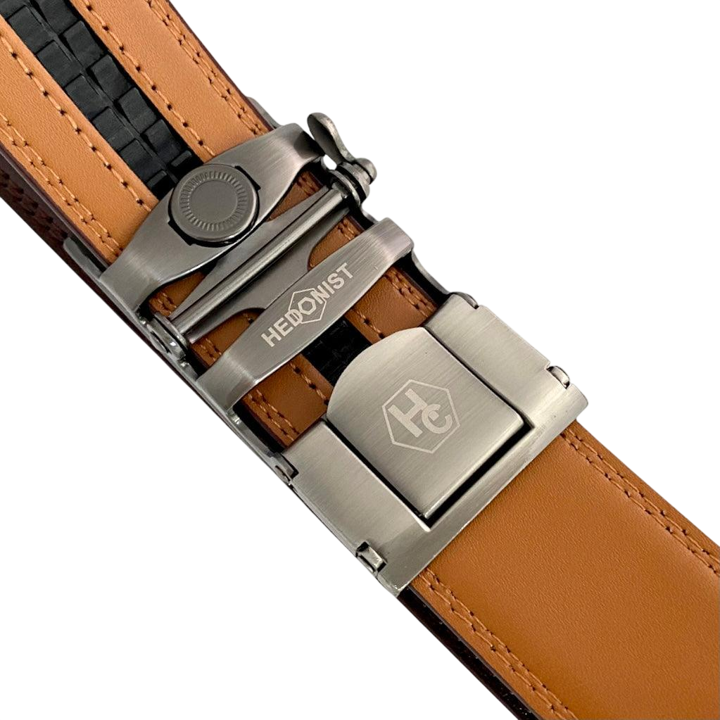 Red-brown leather ratchet belt with gunmetal rectangle buckle, hardware close-up