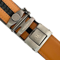 Red-brown leather ratchet belt with long gunmetal rectangle buckle, hardware close-up