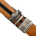 Red-brown leather ratchet belt with silver buckle, buckle close-up