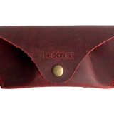 Soft Leather Eye Glasses Case in Red, closed, front view with embossed Hedonist logo and snap closure