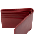 A red leather bifold wallet fully open, showing overall card slot layout