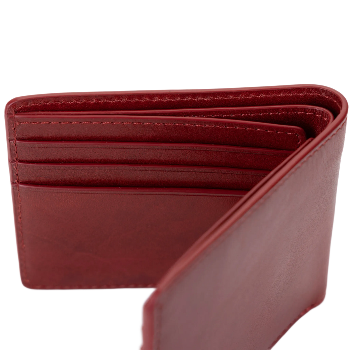 A red leather bifold wallet fully open, showing overall card slot layout