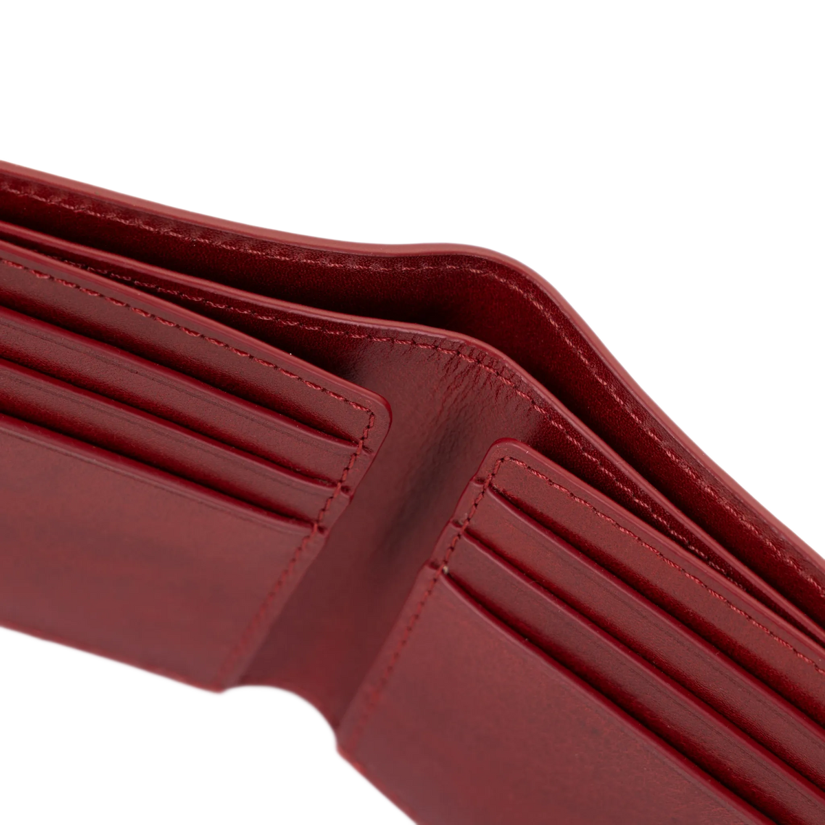 Close-up of an open red leather wallet showing card slots and interior stitching on a white background.