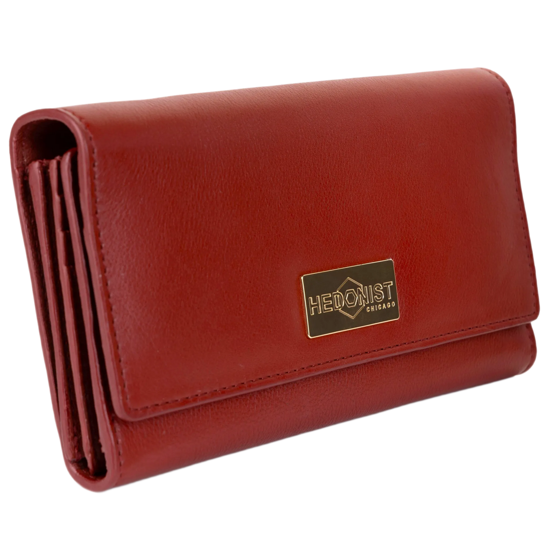 Red pebbled leather trifold wallet for women closed, gold-tone Hedonist Chicago plaque on front