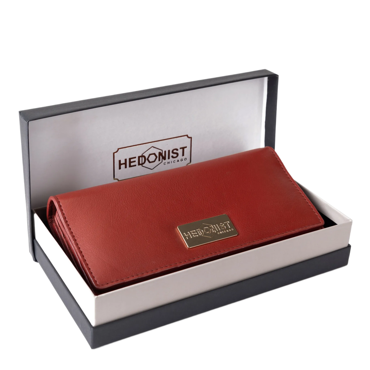 Red pebbled leather trifold wallet presented in Hedonist Chicago branded gift box
