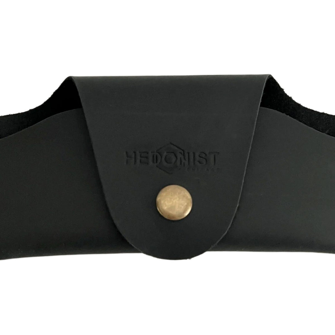 Small Soft Leather Eye Glasses Case in Black, closed, front view with embossed Hedonist logo and snap closure