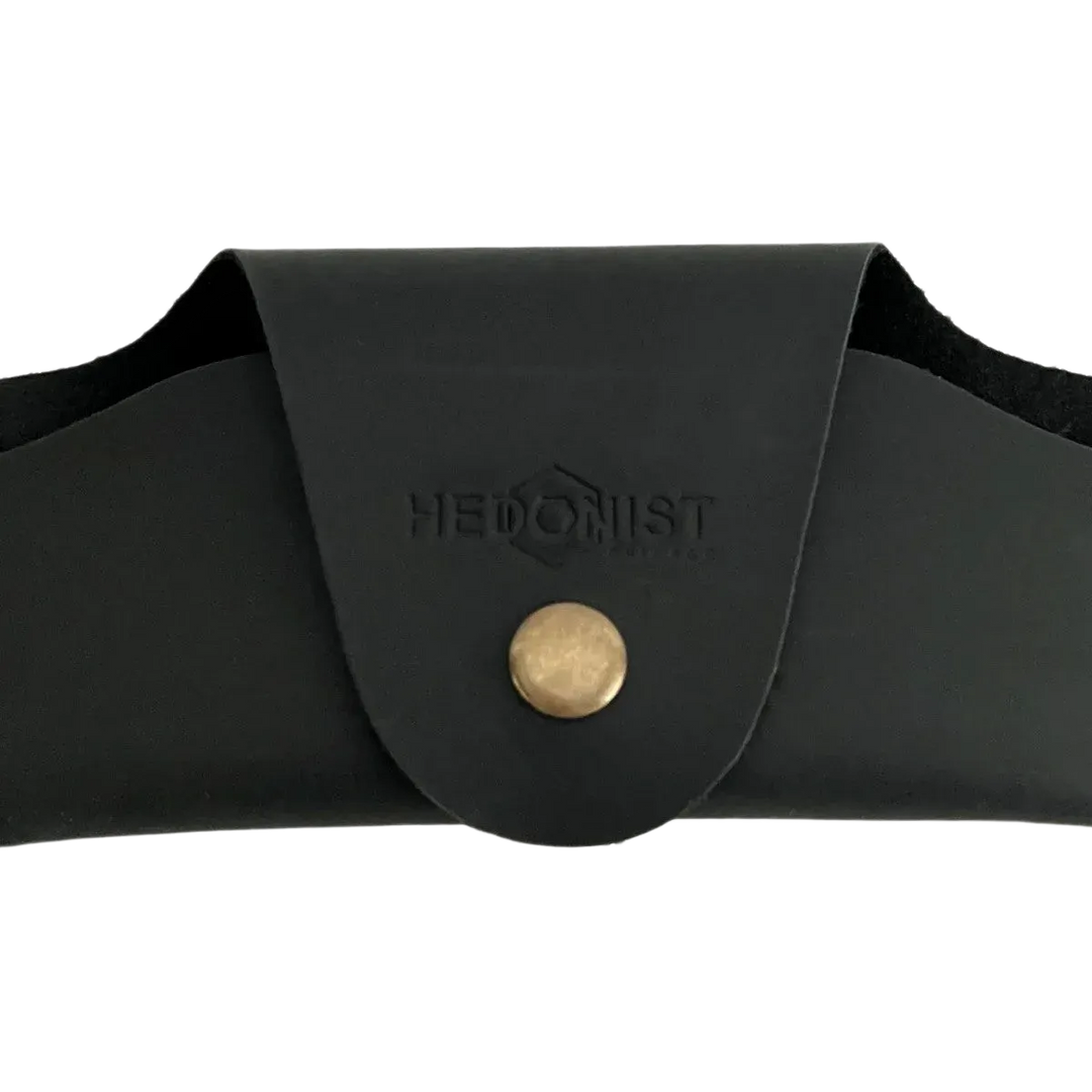 Small Soft Leather Eye Glasses Case in Black, closed, front view with embossed Hedonist logo and snap closure