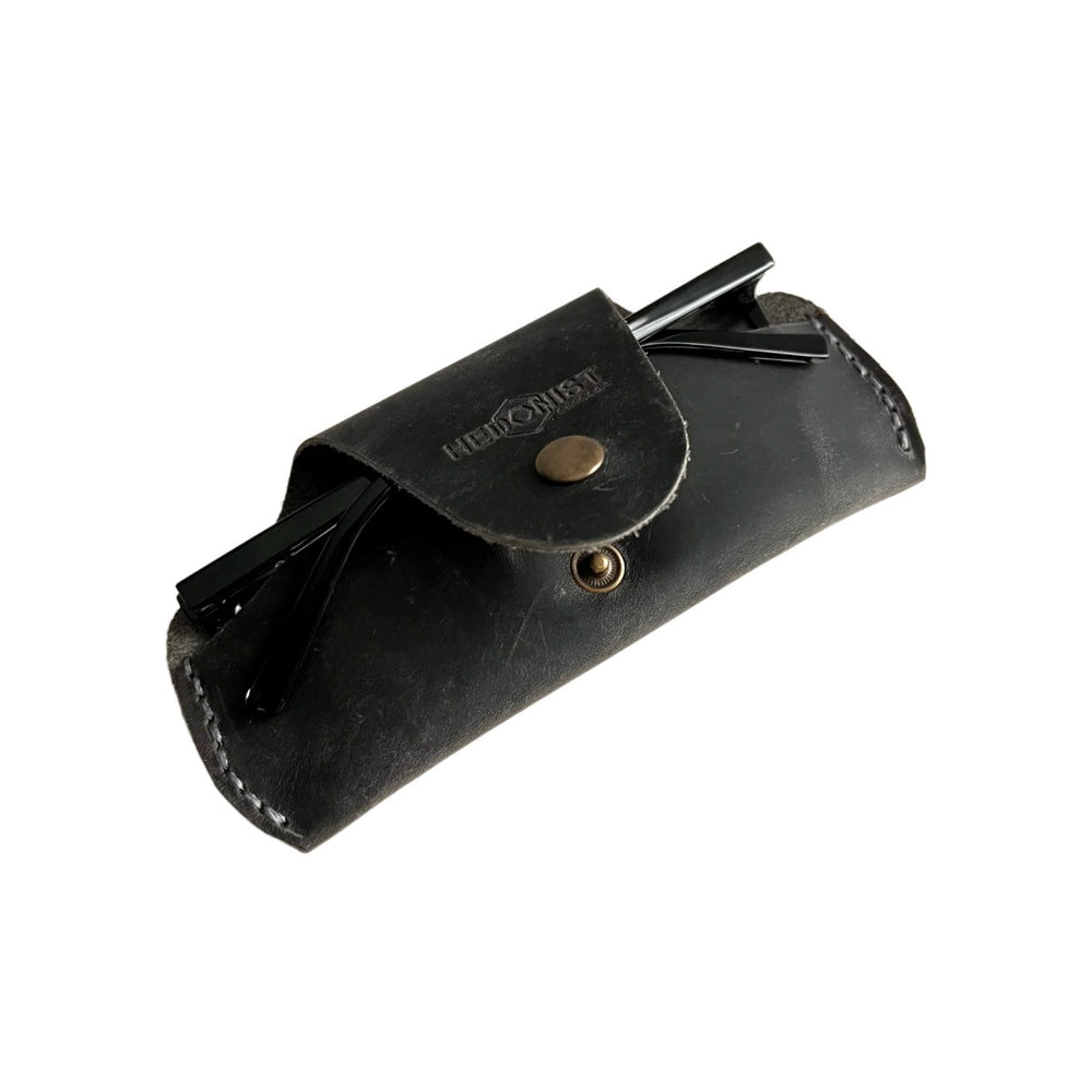 Small Soft Leather Eye Glasses Case in Black Washed, angled view with folded sunglasses tucked inside