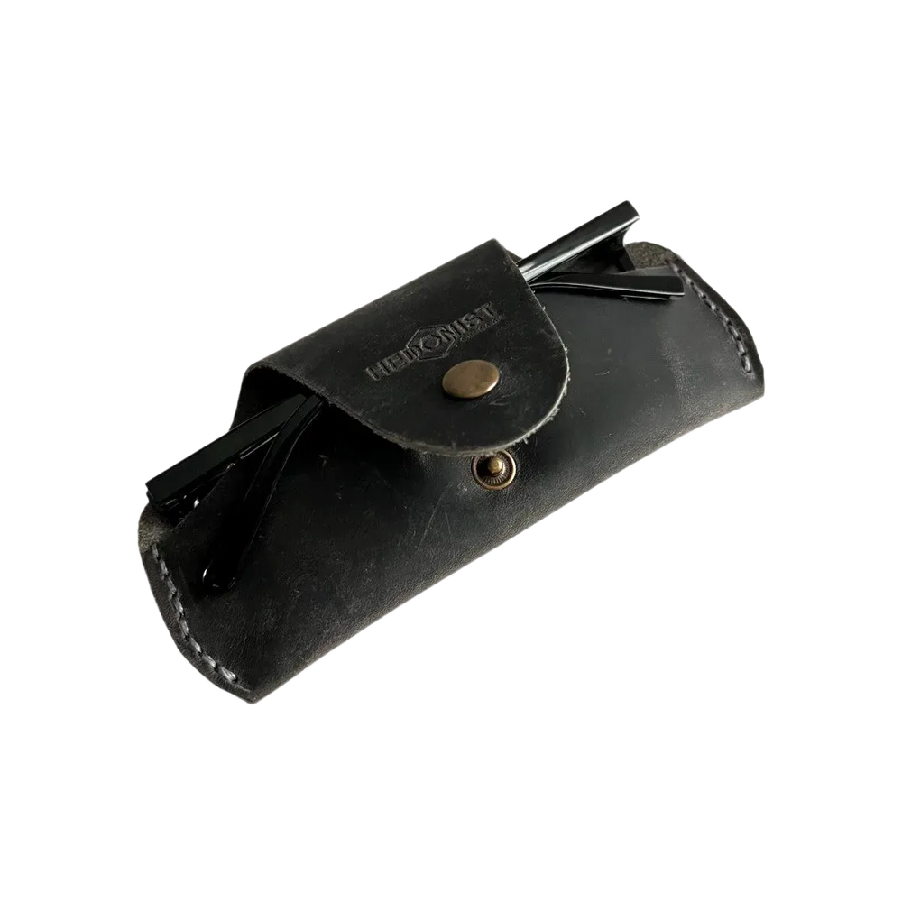 Small Soft Leather Eye Glasses Case in Black Washed, angled view with folded sunglasses tucked inside
