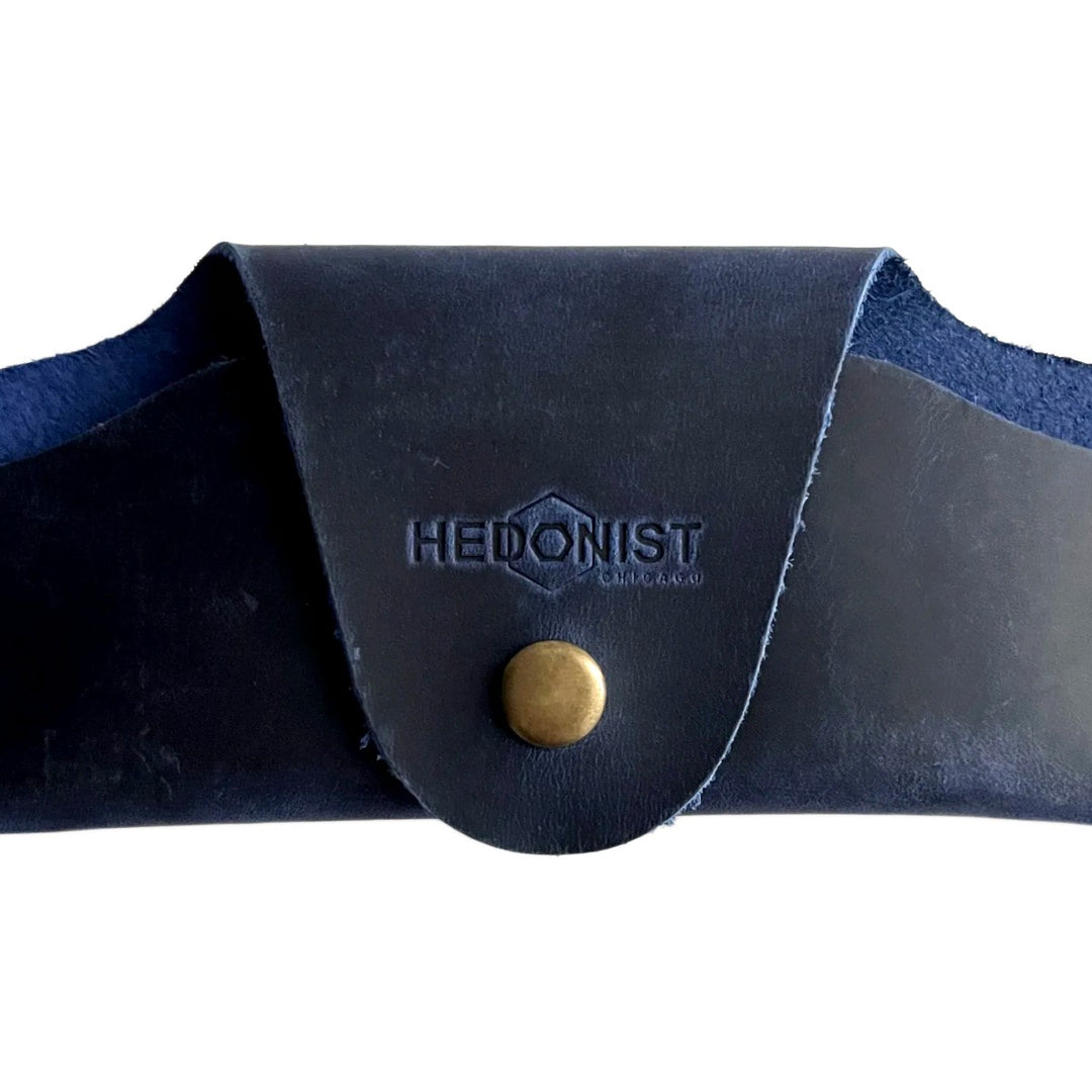 Small Soft Leather Eye Glasses Case in Navy Blue, closed, front view with embossed Hedonist logo and snap closure