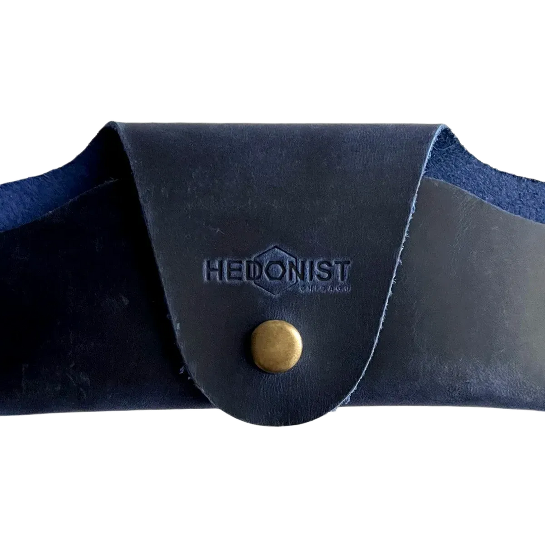 Small Soft Leather Eye Glasses Case in Navy Blue, closed, front view with embossed Hedonist logo and snap closure