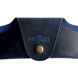 Small Soft Leather Eye Glasses Case in Navy Blue, closed, front view with embossed Hedonist logo and snap closure
