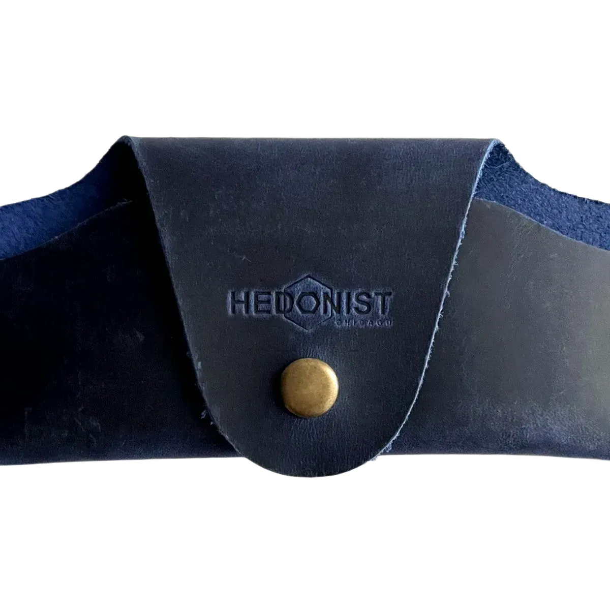Small Soft Leather Eye Glasses Case in Navy Blue, closed, front view with embossed Hedonist logo and snap closure