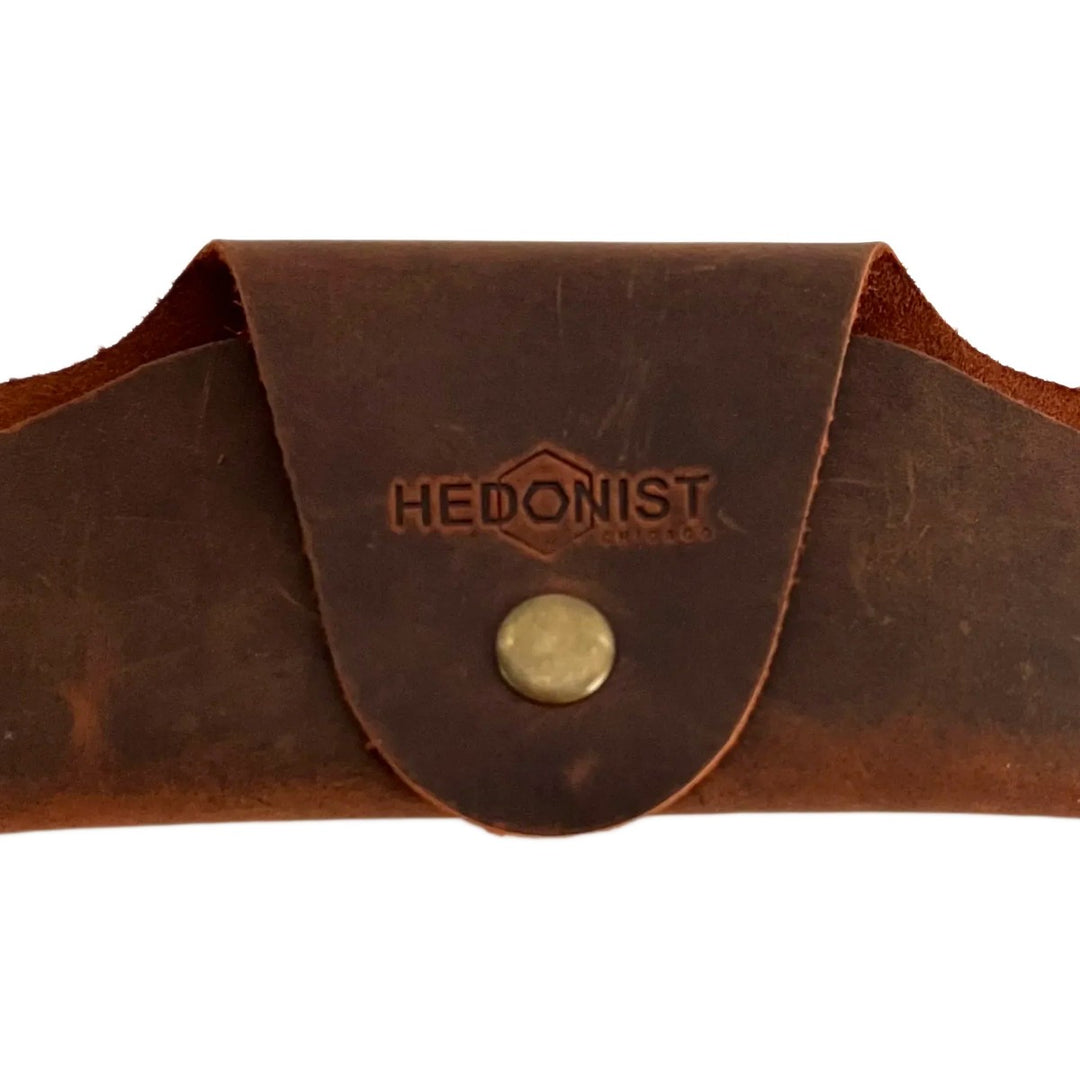 Small Soft Leather Eye Glasses Case in Brown, closed, front view with embossed Hedonist logo and snap closure