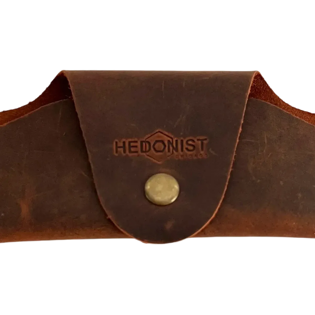 Small Soft Leather Eye Glasses Case in Brown, closed, front view with embossed Hedonist logo and snap closure