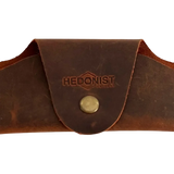 Small Soft Leather Eye Glasses Case in Brown, closed, front view with embossed Hedonist logo and snap closure