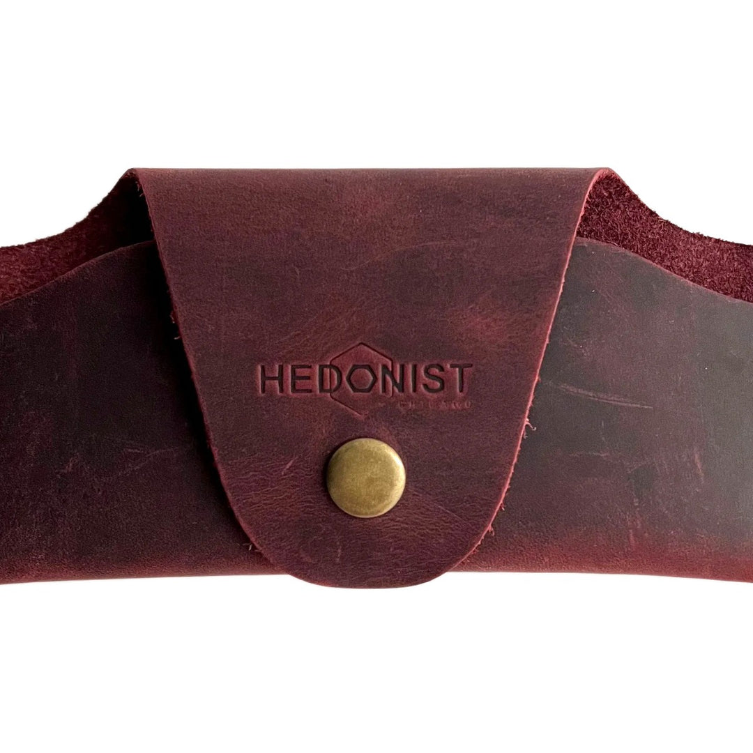 Small Soft Leather Eye Glasses Case in Burgundy, closed, front view with embossed Hedonist logo and snap closure
