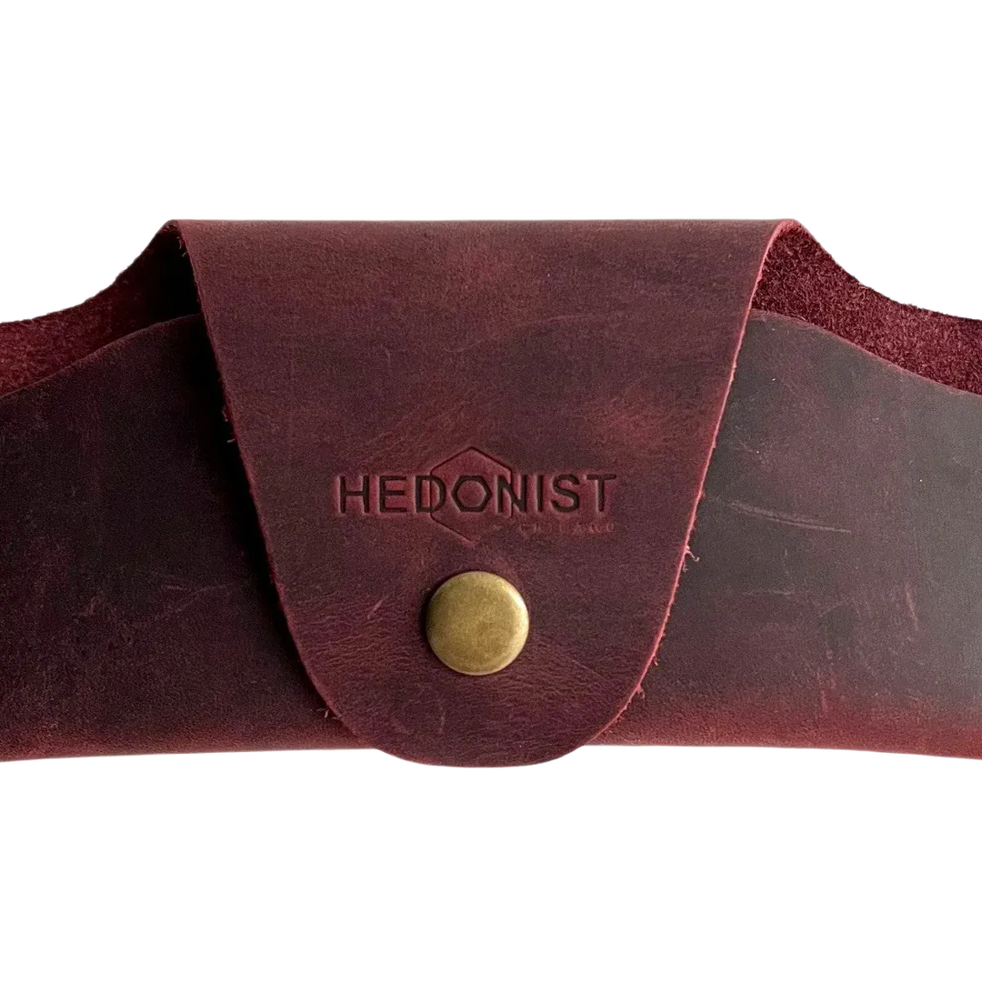 Small Soft Leather Eye Glasses Case in Burgundy, closed, front view with embossed Hedonist logo and snap closure