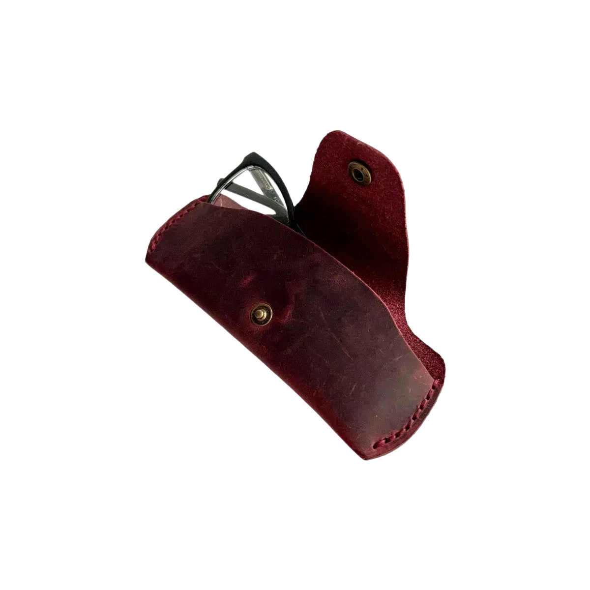 Small Soft Leather Eye Glasses Case in Burgundy, angled view with black-framed eyeglasses tucked inside