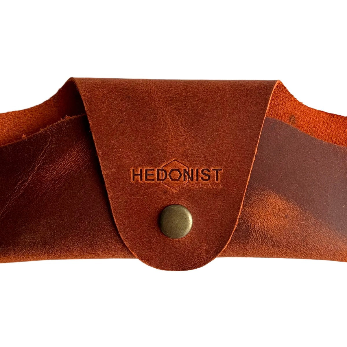 Small Soft Leather Eye Glasses Case in Cognac, closed, front view with embossed Hedonist logo and snap closure