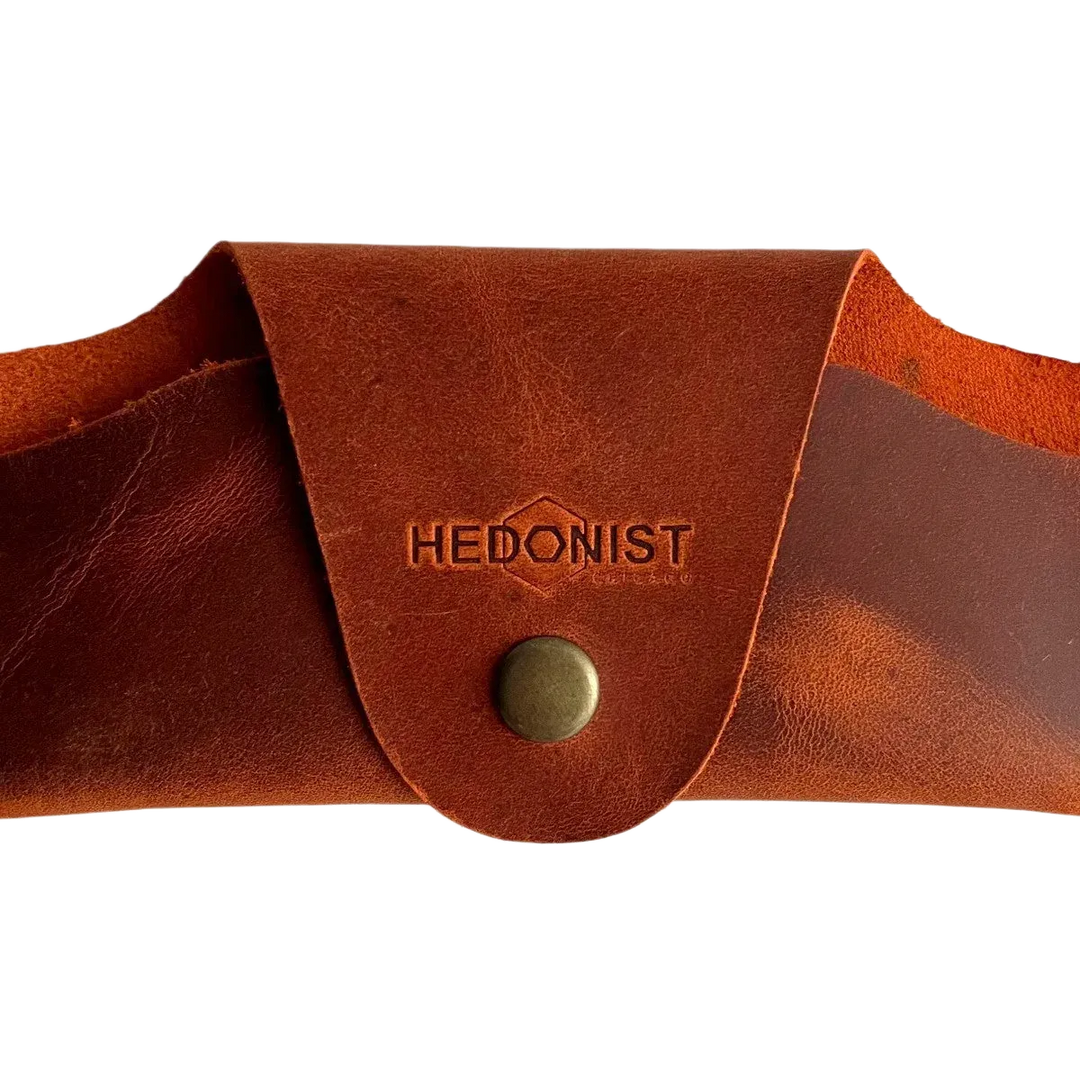 Small Soft Leather Eye Glasses Case in Cognac, closed, front view with embossed Hedonist logo and snap closure