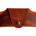 Small Soft Leather Eye Glasses Case in Cognac, closed, front view with embossed Hedonist logo and snap closure