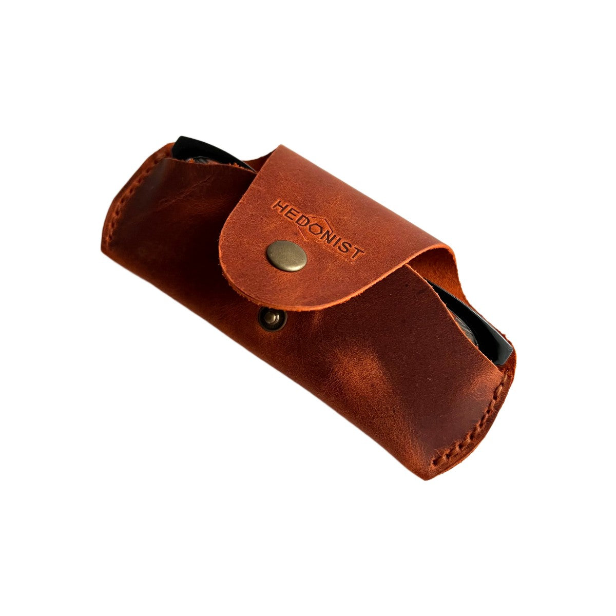 Small Soft Leather Eye Glasses Case in Cognac, angled view with folded sunglasses peeking out