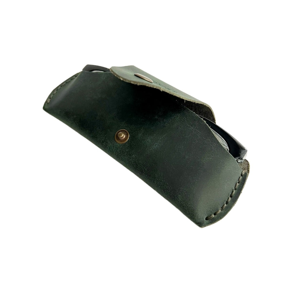 Small Soft Leather Eye Glasses Case in Dark Green, open, angled top view with black-framed eyeglasses inside