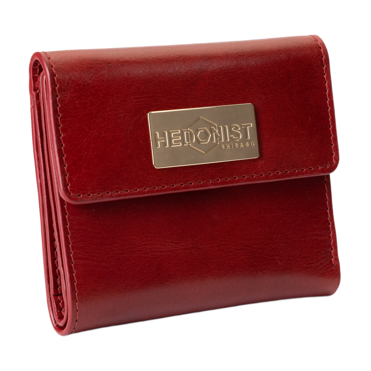 A red leather bi-fold wallet with a gold-tone metal brand plaque on the front flap.