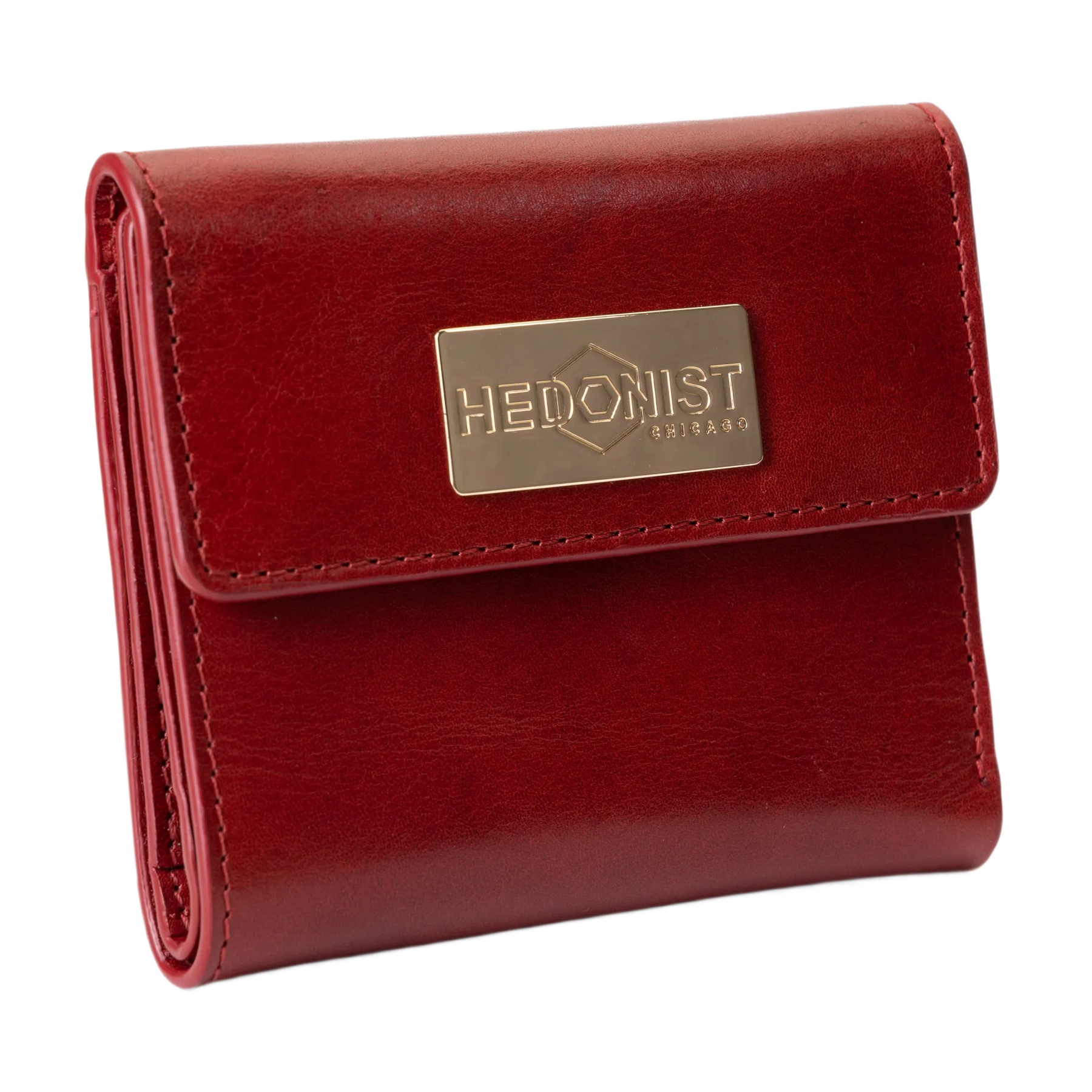 A red leather bi-fold wallet with a gold-tone metal brand plaque on the front flap.