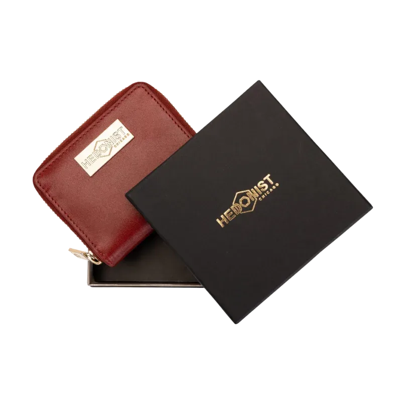 Small red zip-around leather wallet for women, presented as a gift