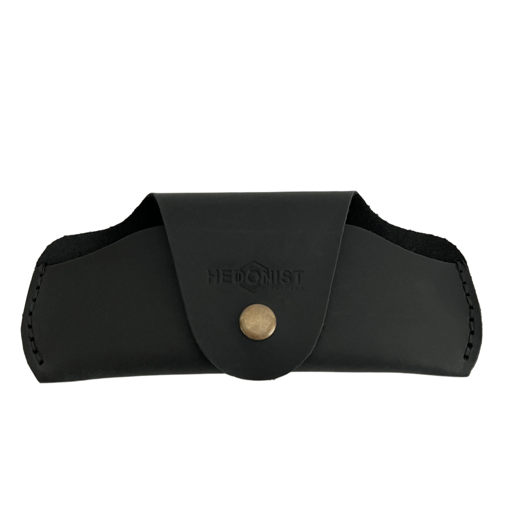 Small Soft Leather Eye Glasses Case in Black, closed, front view with embossed Hedonist logo and snap closure