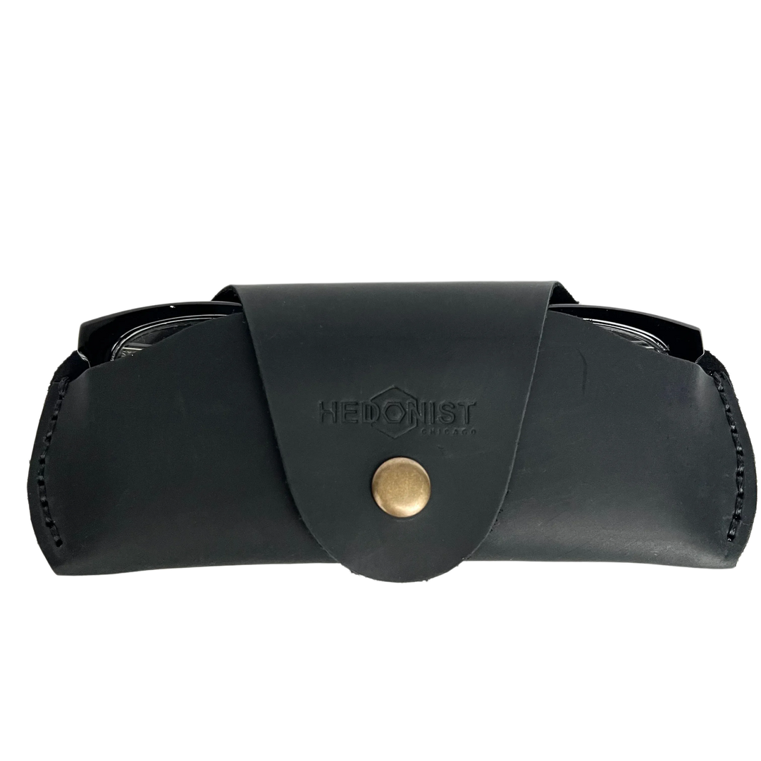 Small Soft Leather Eye Glasses Case in Black, closed, with sunglasses temples visible poking out both sides