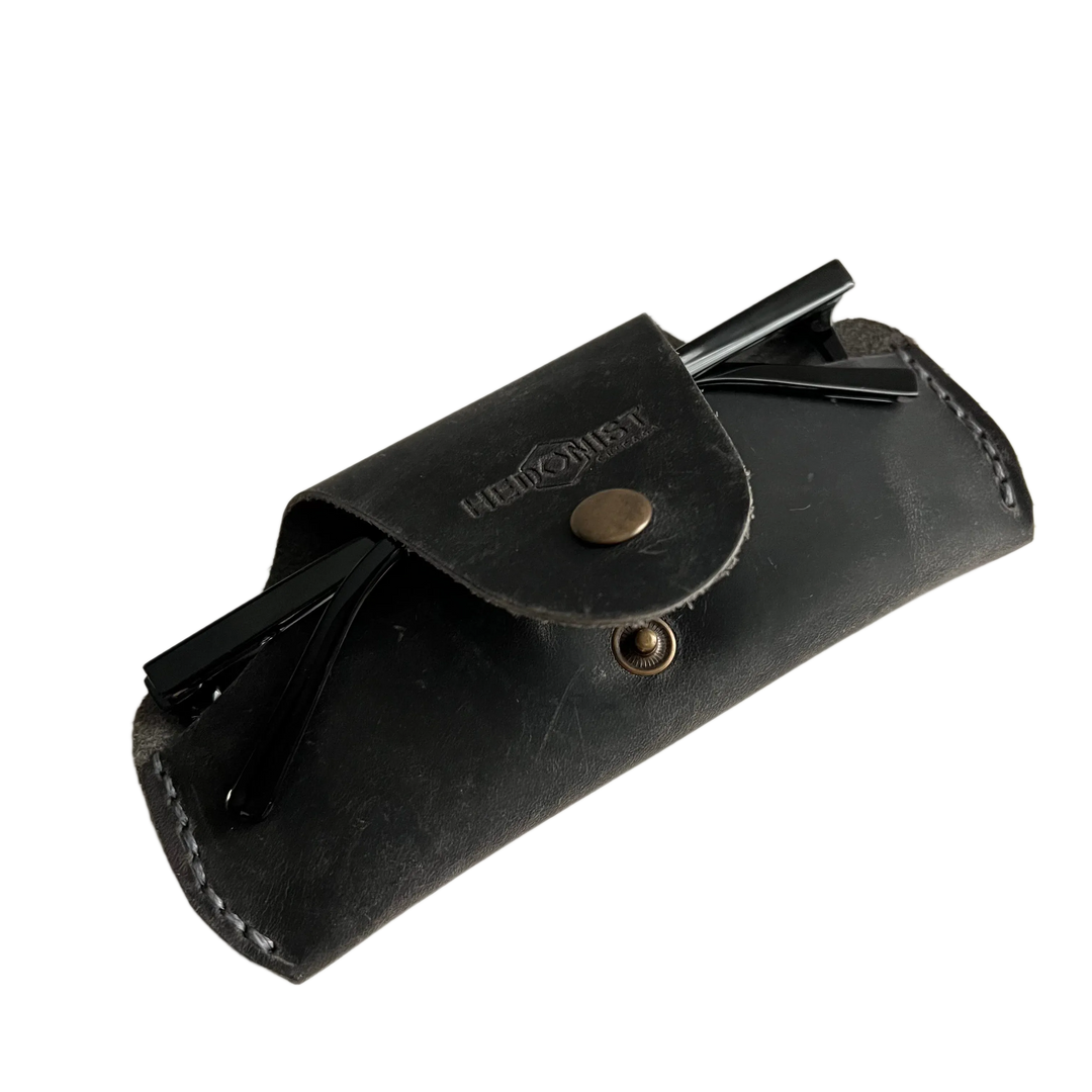 Small Soft Leather Eye Glasses Case in Black Washed, angled view with folded sunglasses tucked inside