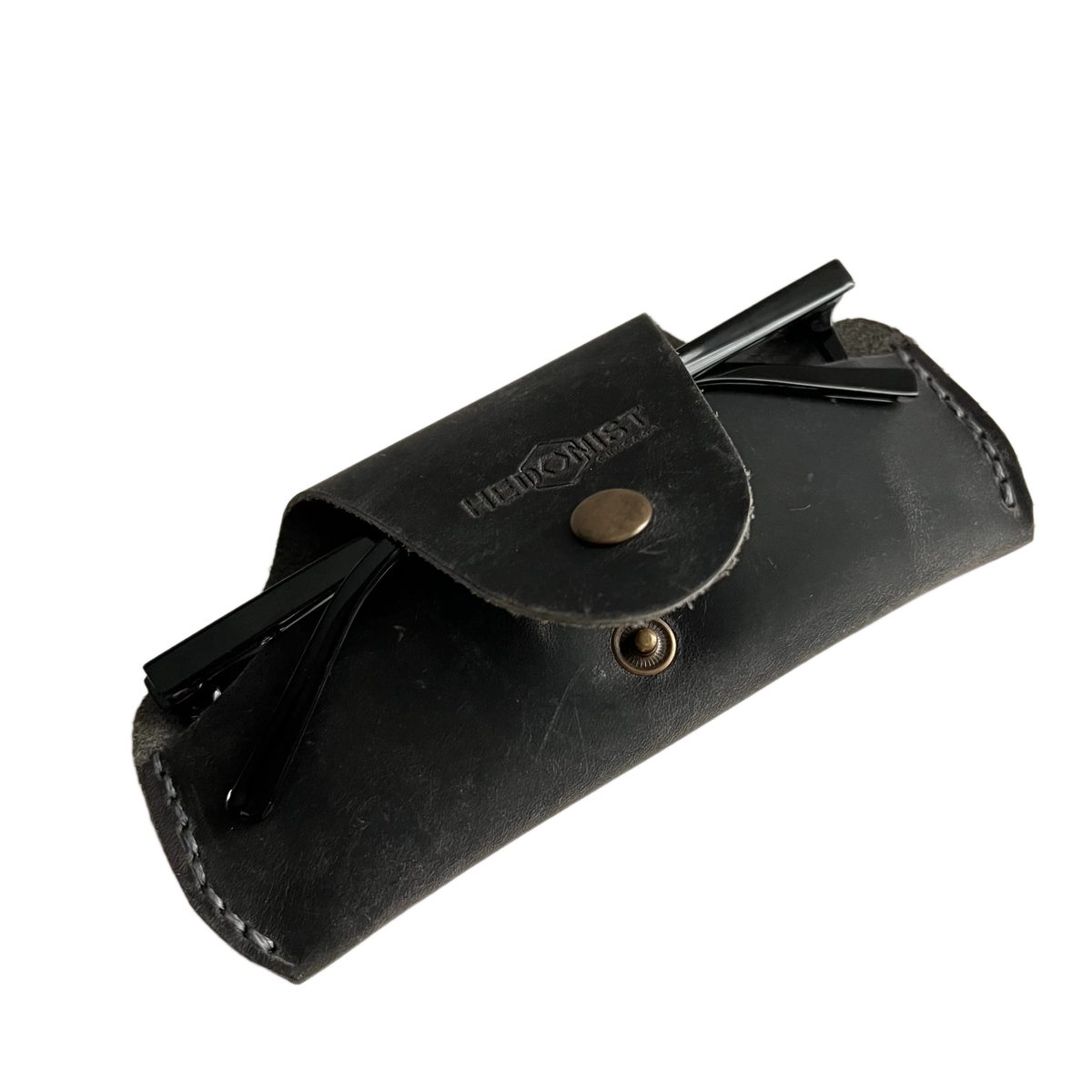 Small Soft Leather Eye Glasses Case in Black Washed, angled view with folded sunglasses tucked inside