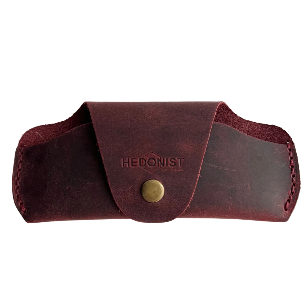 Small Soft Leather Eye Glasses Case in Burgundy, closed, front view with embossed Hedonist logo and snap closure