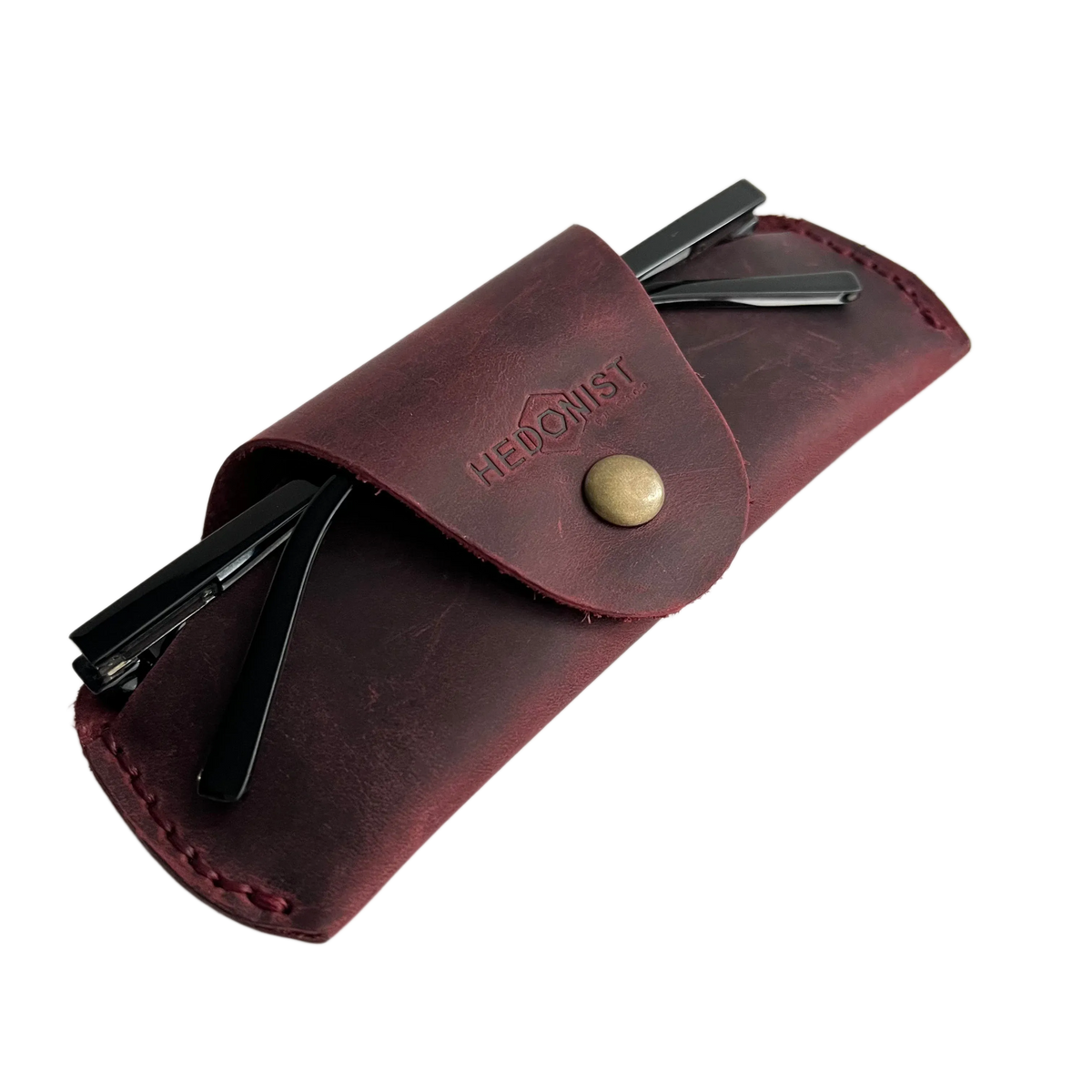 Small Soft Leather Eye Glasses Case in Burgundy, angled view with sunglasses temples visible poking out both sides