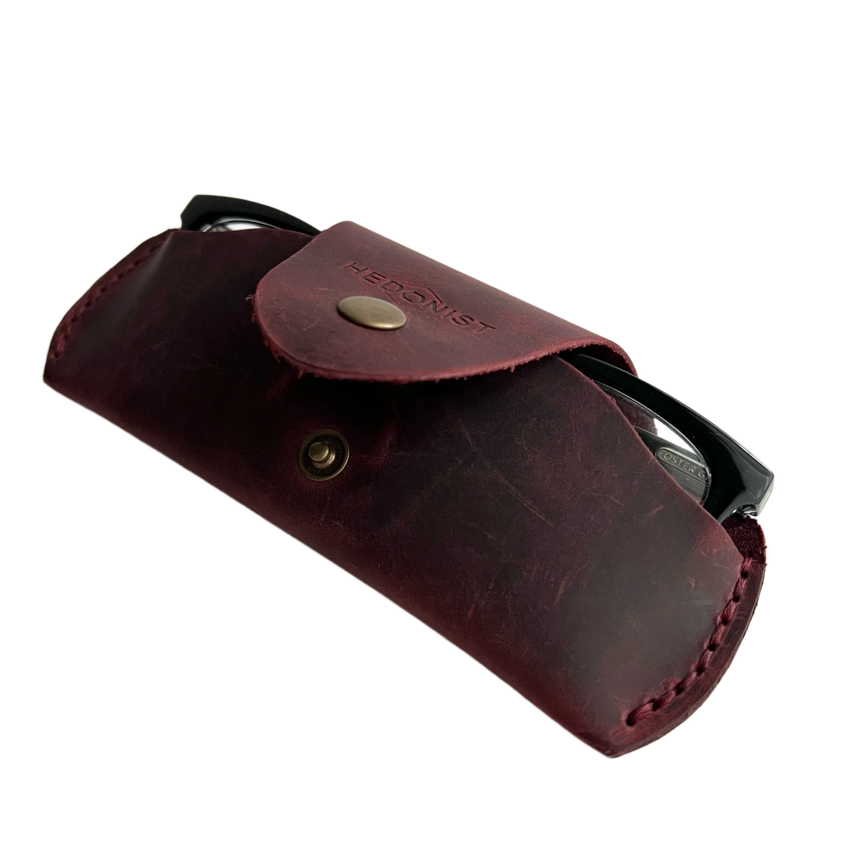 Small Soft Leather Eye Glasses Case in Burgundy, open, angled top view with black-framed eyeglasses inside