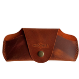 Small Soft Leather Eye Glasses Case in Cognac, closed, front view with embossed Hedonist logo and snap closure