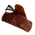 Small Soft Leather Eye Glasses Case in Cognac, open, with black-framed eyeglasses inside