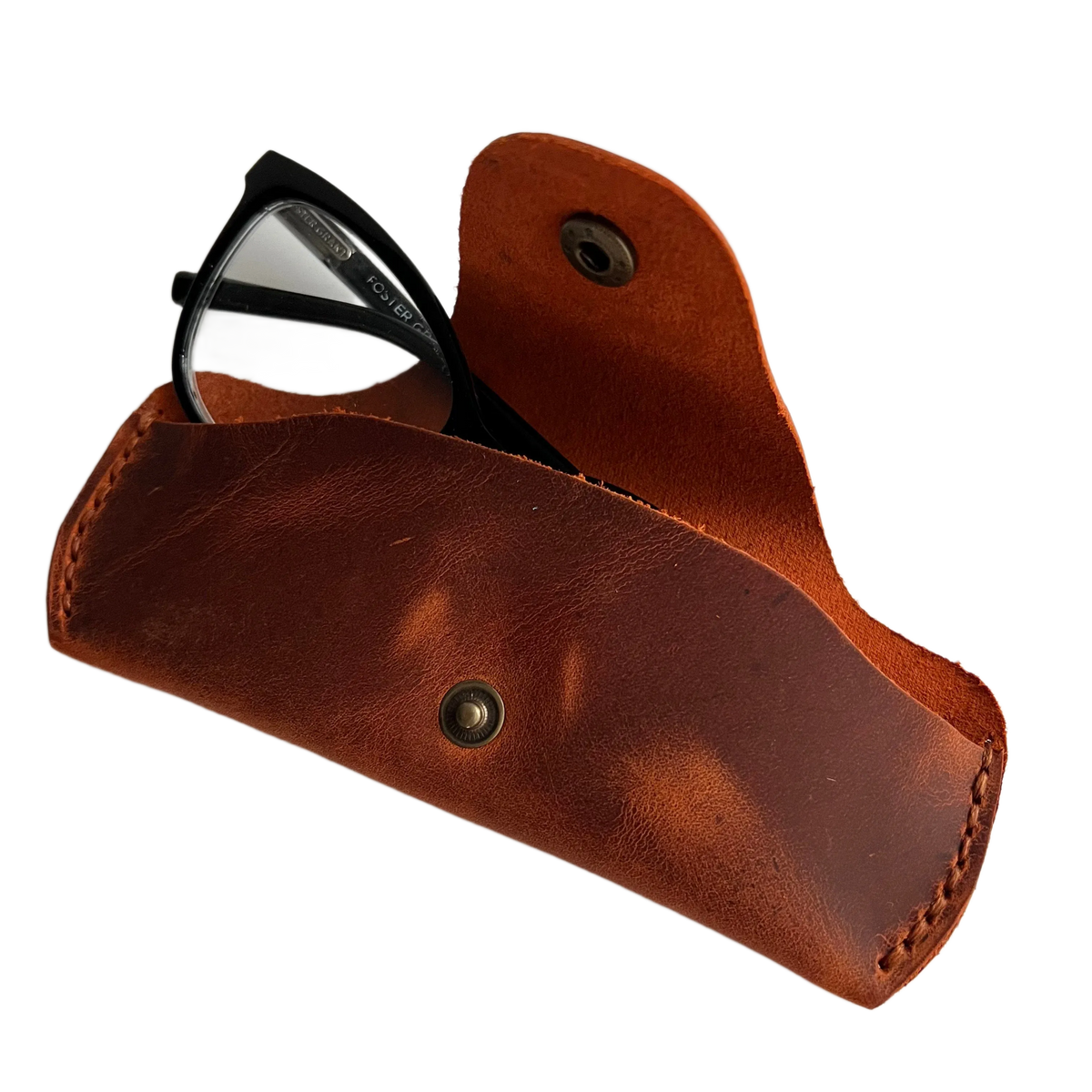 Small Soft Leather Eye Glasses Case in Cognac, open, with black-framed eyeglasses inside