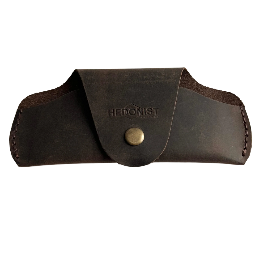 Small Soft Leather Eye Glasses Case in Dark Brown, closed, front view with embossed Hedonist logo and snap closure