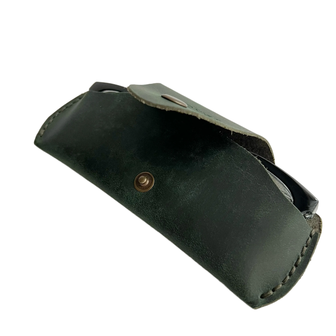 Small Soft Leather Eye Glasses Case in Dark Green, open, angled top view with black-framed eyeglasses inside