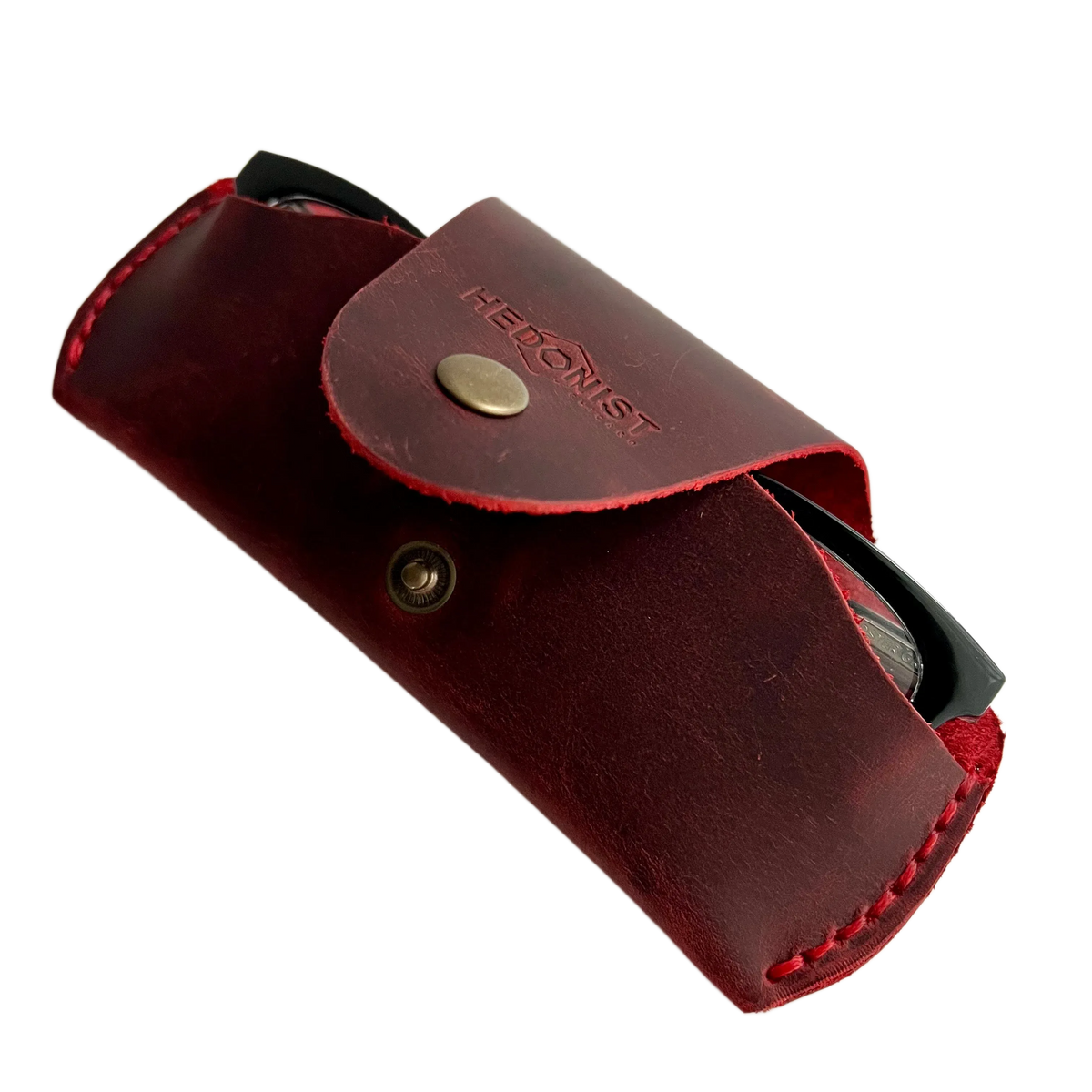 Small Soft Leather Eye Glasses Case in Red, angled view with black-framed eyeglasses tucked inside